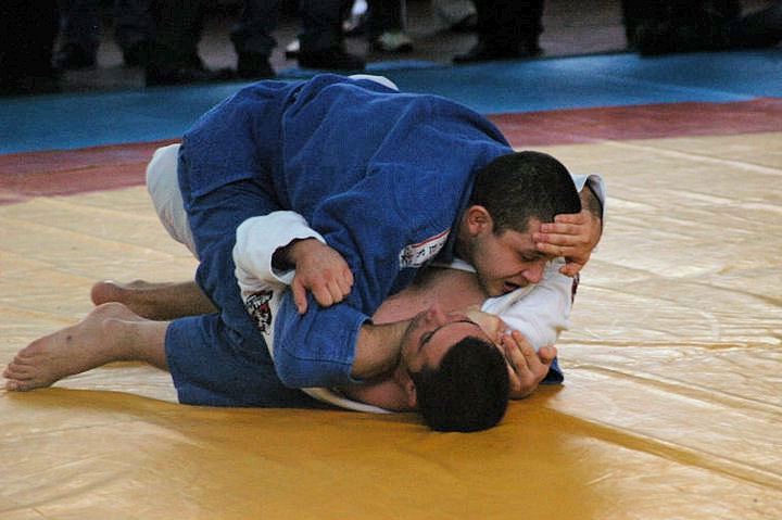 Two jiu-jitsu students training on a mat
