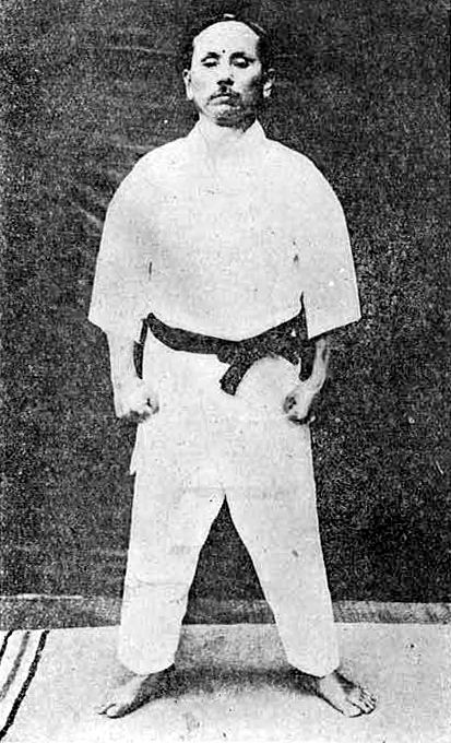 Gichin Funakoshi standing in the ready position of a kata