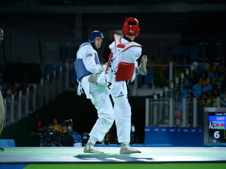 Two taekwondo athletes in protective gear competing at the Rio 2016 Olympics
